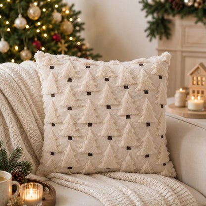 Housse de coussin Sapins Enchantés écru, avec sapins en relief, dans un salon chaleureux décoré pour Noël.